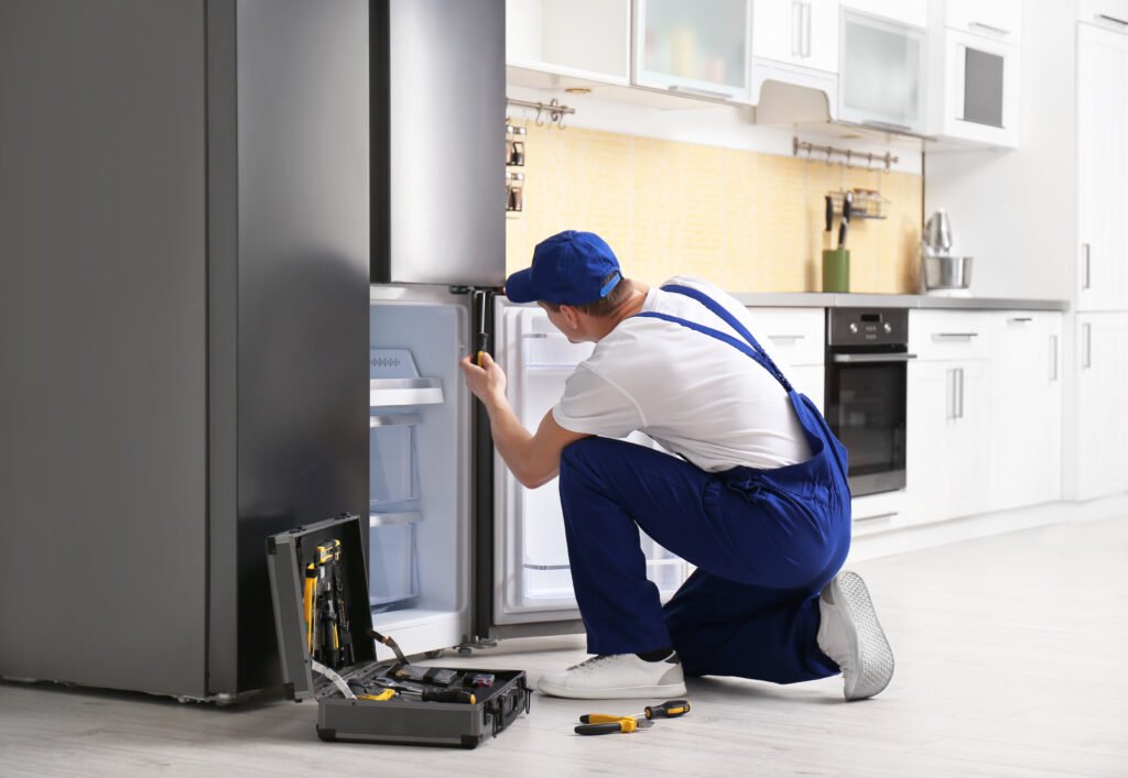 Technician repairing a residential refrigerator in Chicago